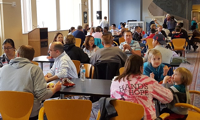 IFP hosts, their families and guests enjoy an indoor picnic together in the Krannert Drawing Room. 